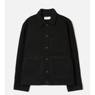 A black long-sleeve button-up jacket with a pointed collar, a chest pocket, and two large front patch pockets, shown flat against a light off-white background.
