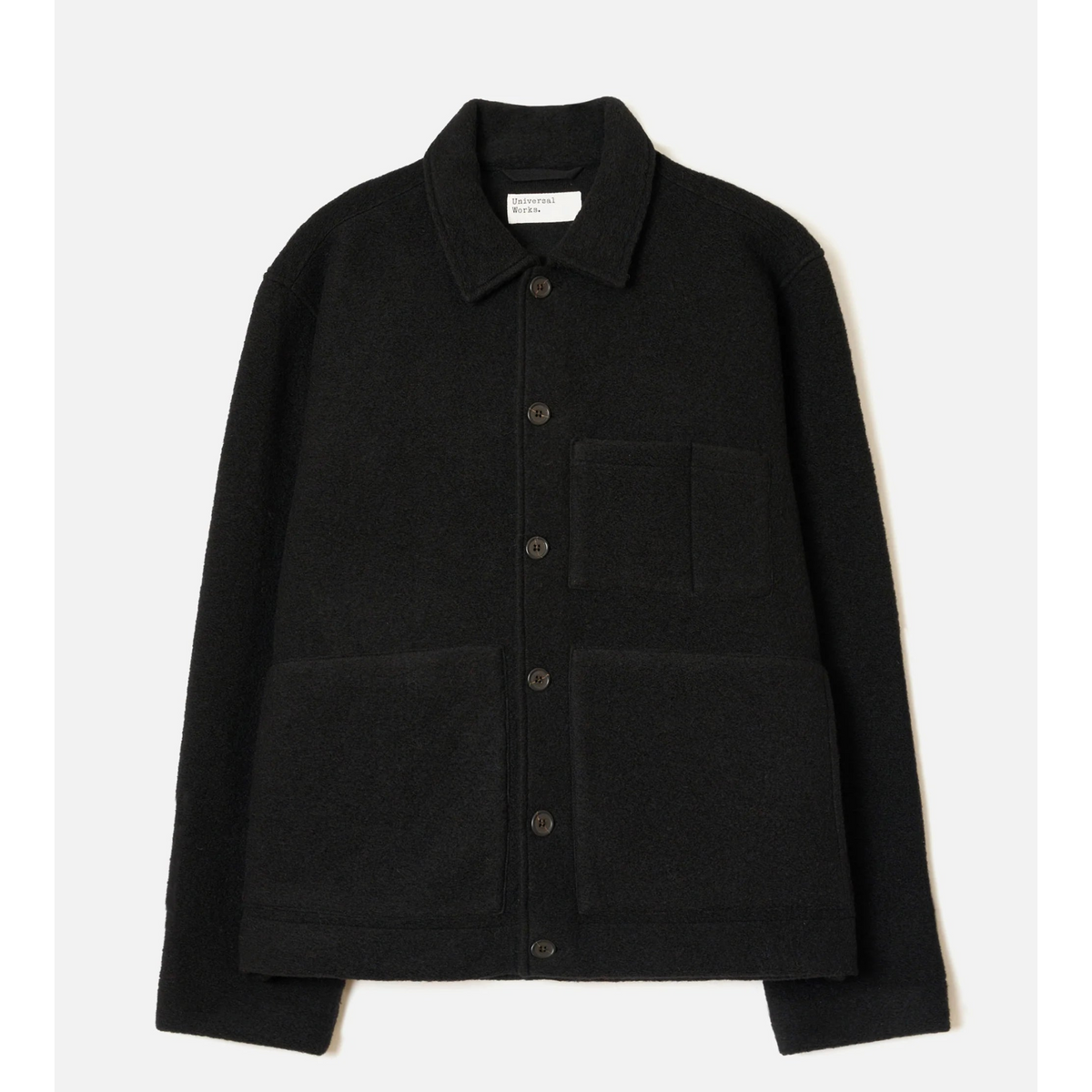 A black long-sleeve button-up jacket with a pointed collar, a chest pocket, and two large front patch pockets, shown flat against a light off-white background.