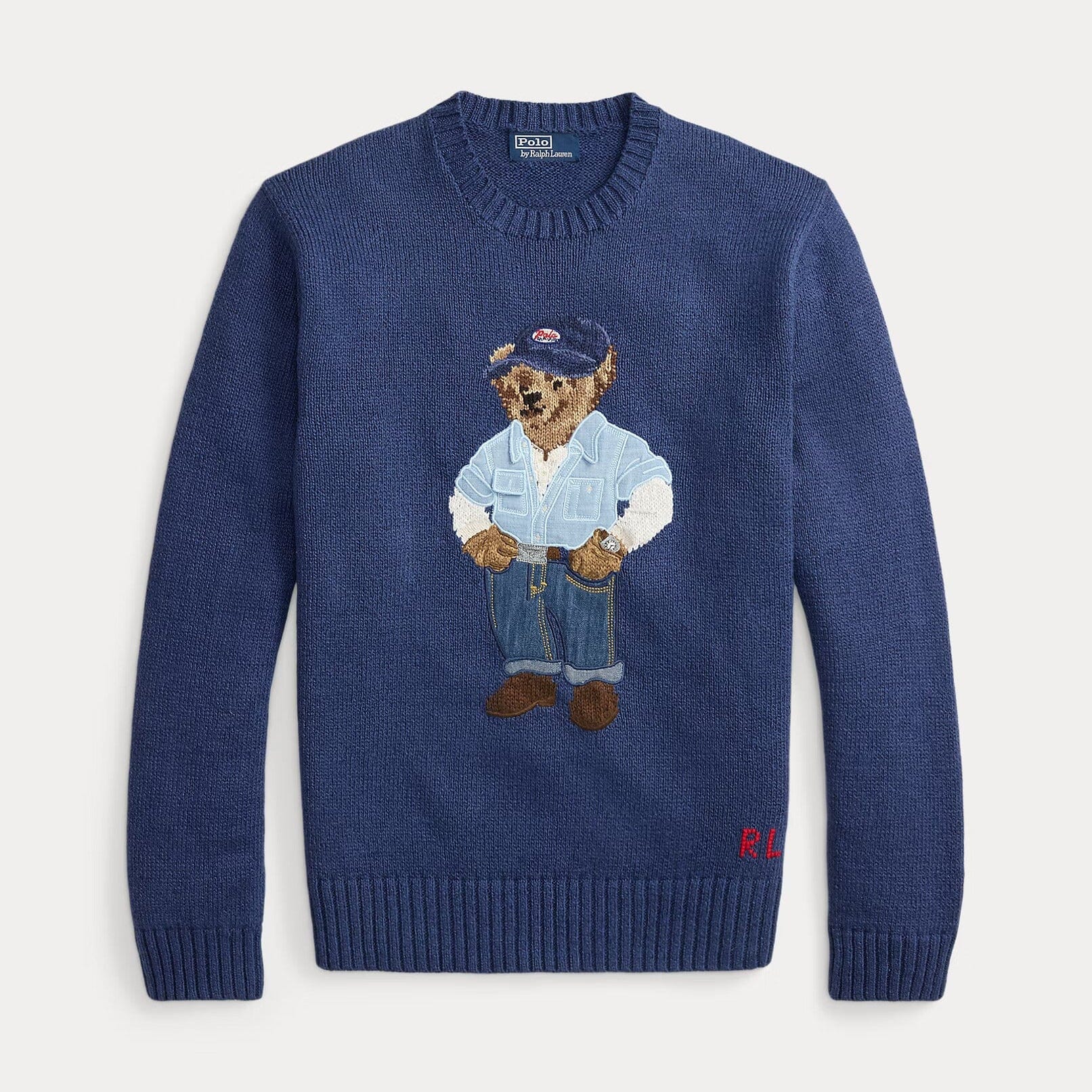 Blue sweater with embroidered bear design on a light gray background