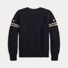 A dark navy blue knit sweater shown from the back, featuring two beige stripes and a beige star on each sleeve, set against a light gray background.